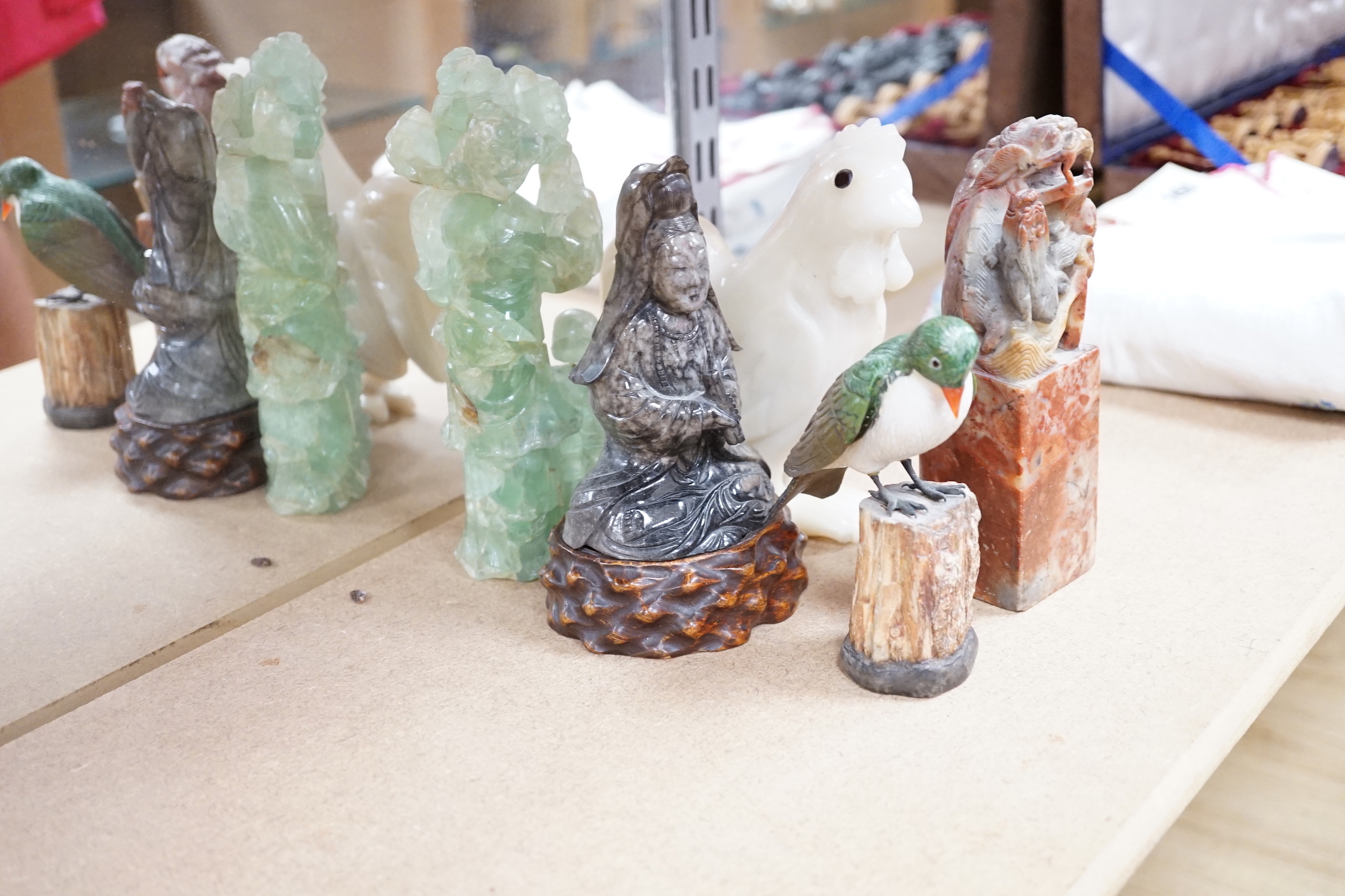 A collection of assorted Chinese hardstone carvings, boxes etc, including a Chinese jadeite carving of a lady, 7.8cm high, wood stand